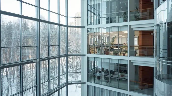 Blick durch die Glasfassade eines mehrgeschossigen Bürogebäudes